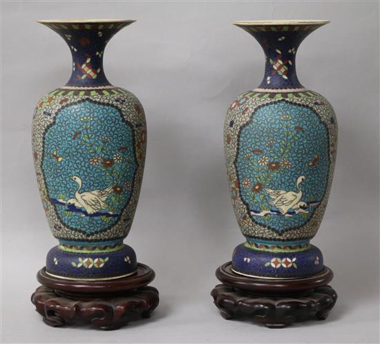 A pair of Japanese ceramic cloisonne vases, on stands height 22cm
